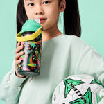 Young girl holding a sports bottle and soccer ball against a teal background